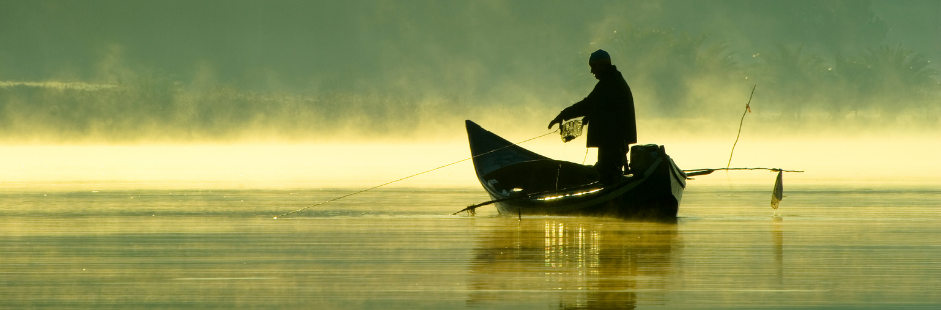 lake fishing Man in a boat fishing on a lake